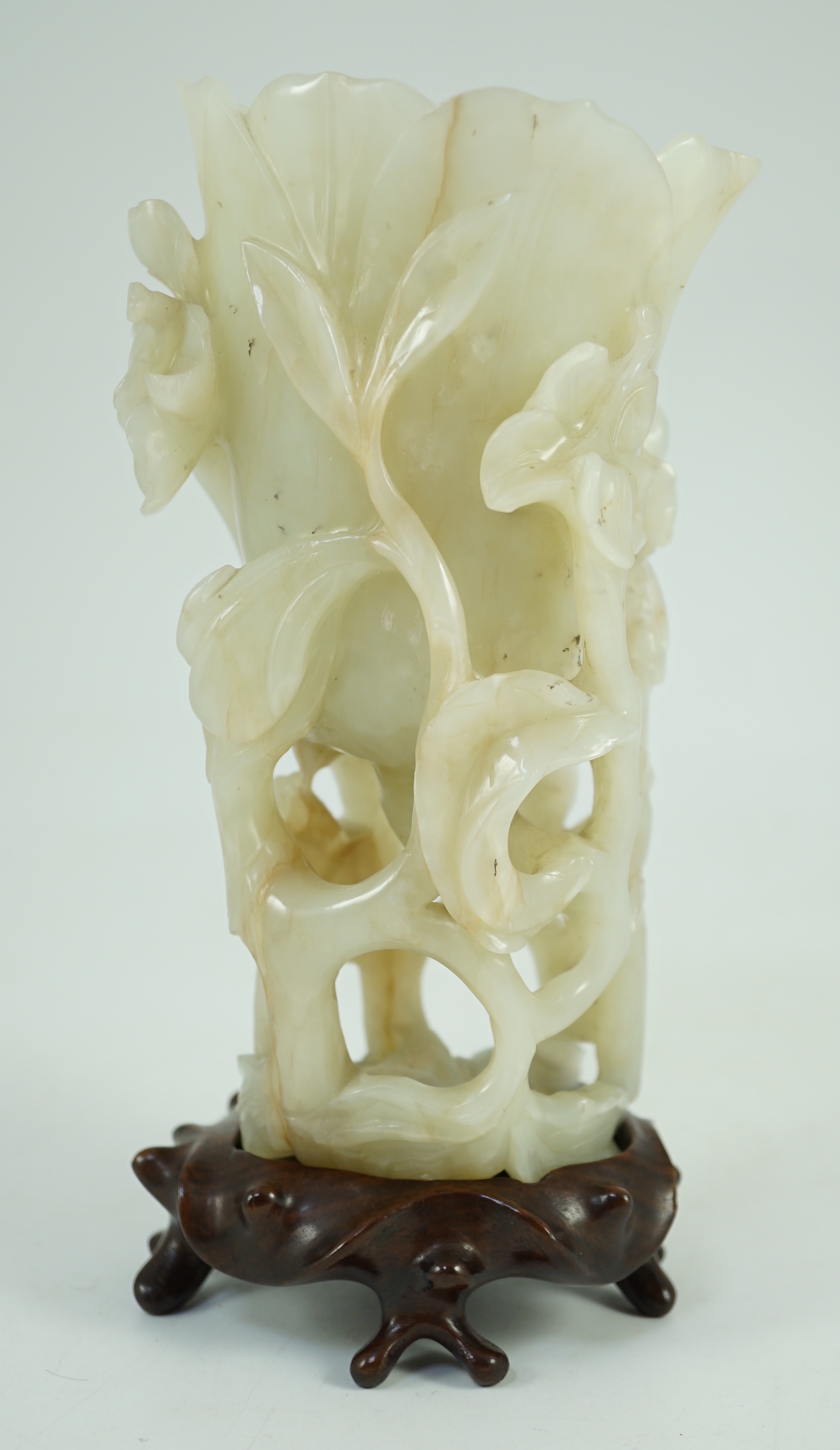 A large Chinese pale celadon jade ‘magnolia’ cup, 17th/18th century 17.5cm high excluding wood stand